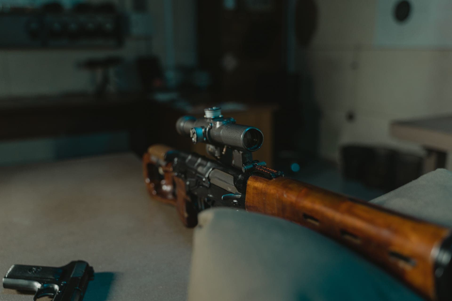 A bolt-action hunting rifle with a scope on a rest
